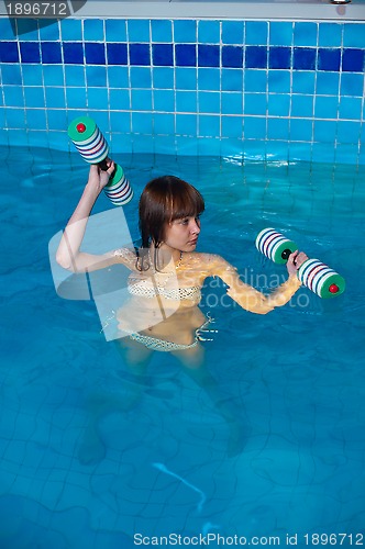 Image of Pretty girl doing aqua aerobic exercise