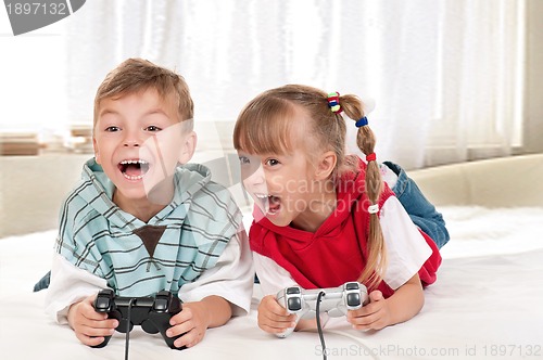 Image of Happy girl and boy playing a video game