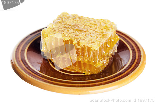 Image of spoon with honeycomb  on white plate