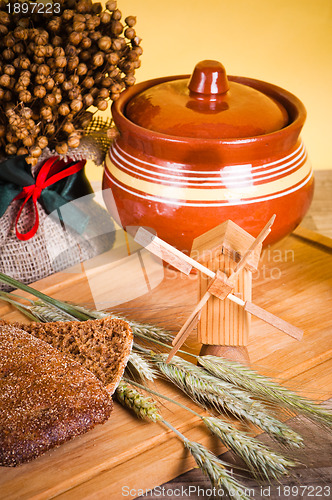 Image of sliced bread and wheat on the wooden table 