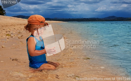 Image of toddler sitting in the water