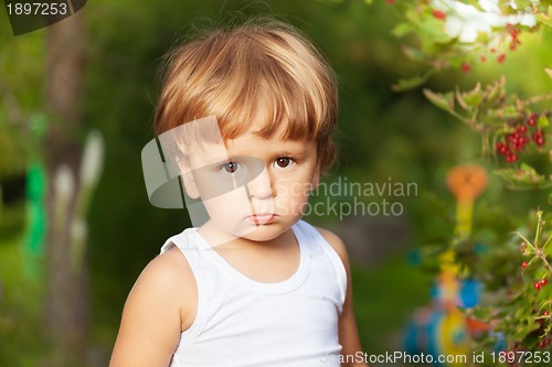 Image of moody kid in the garden