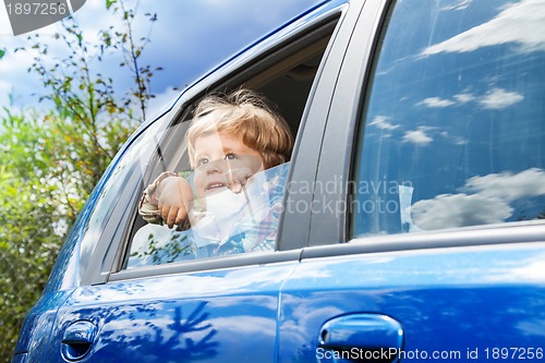 Image of little boy on the back car sit