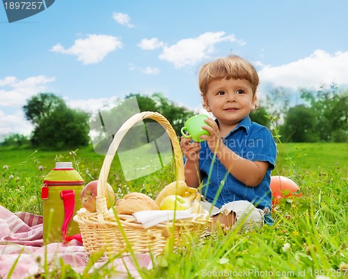 Image of little boy drinking on picnic