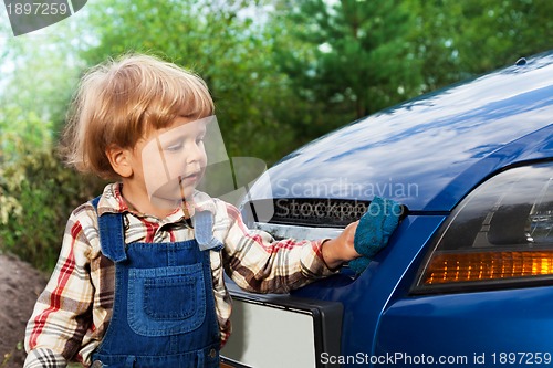 Image of kid washing car with sponge