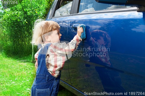Image of Cute kid washing parents car
