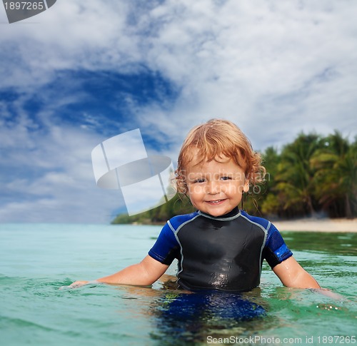 Image of Happy toddler in wet suit