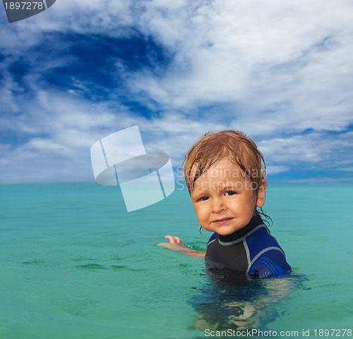 Image of cute kid in wetsuit