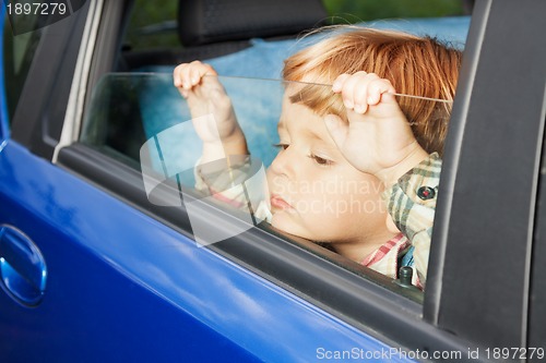 Image of sad kid tired of trip