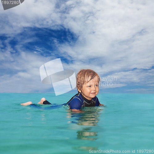 Image of Little boy laying in the water