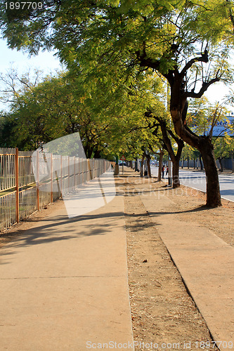 Image of Long Empty Sunny Sidewalk