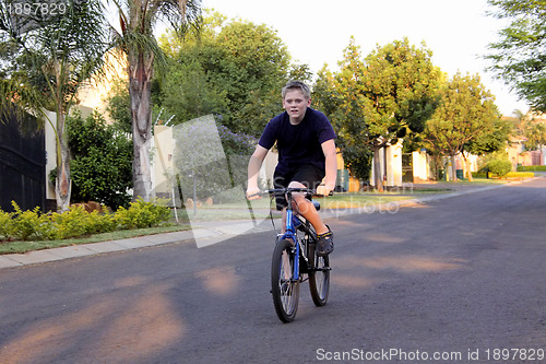 Image of Young Boy Riding Bicycle
