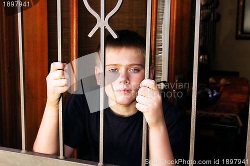 Image of Young Boy Locked Inside House for Protection