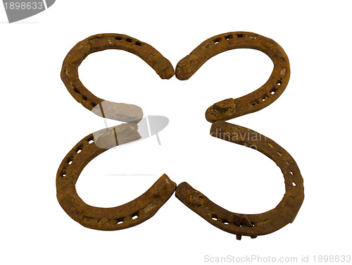 Image of concept clover made of retro horseshoes isolated 