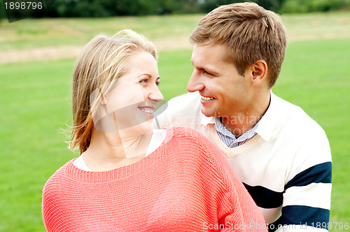 Image of Couple admiring each other and smiling heartily