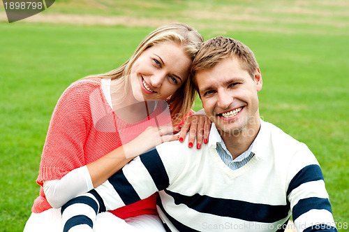 Image of Adorable love couple, woman embracing her man