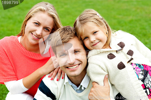 Image of Joyous family of three. Loving and caring