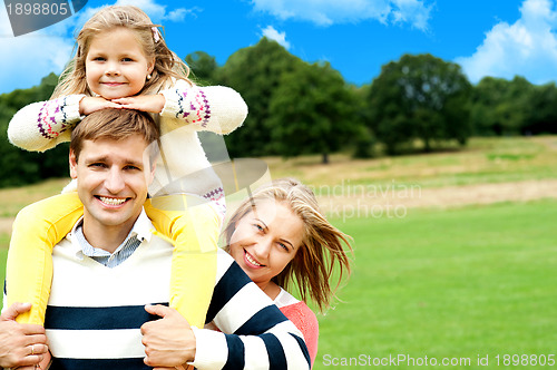 Image of Family's day out in the park. Everyone enjoying