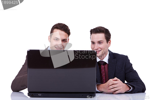 Image of Two business men working on their laptop
