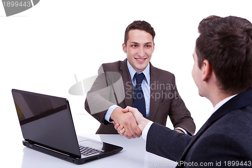 Image of  business men reaching to an agreement 