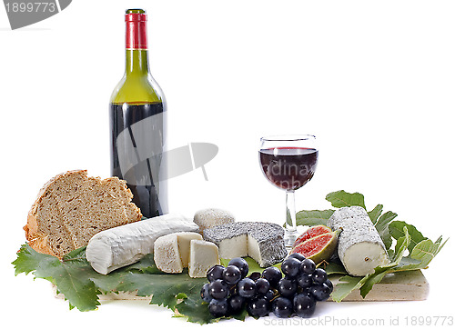 Image of goat cheeses, fruits and wine