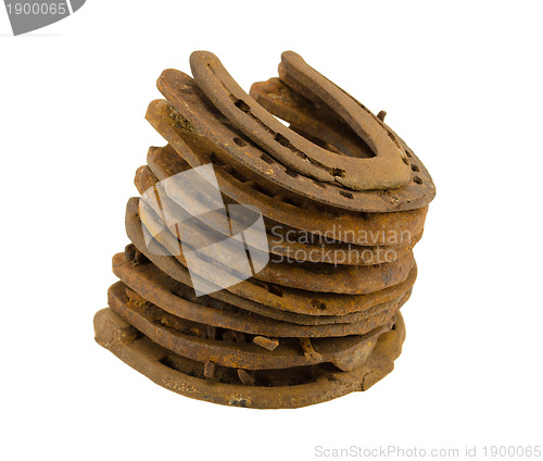 Image of stack of old retro horse shoes isolated on white 