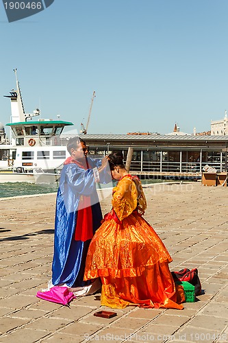 Image of 16. Jul 2012 - Couple preparing for posing to tourists in Venice, Italy