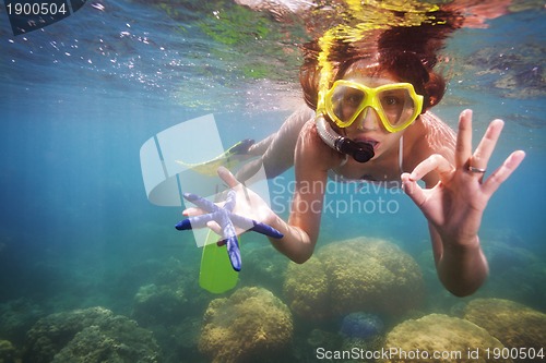 Image of girl in scuba mask holding starfish