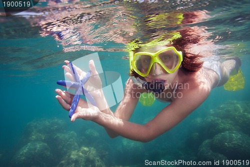 Image of Woman holding starfish