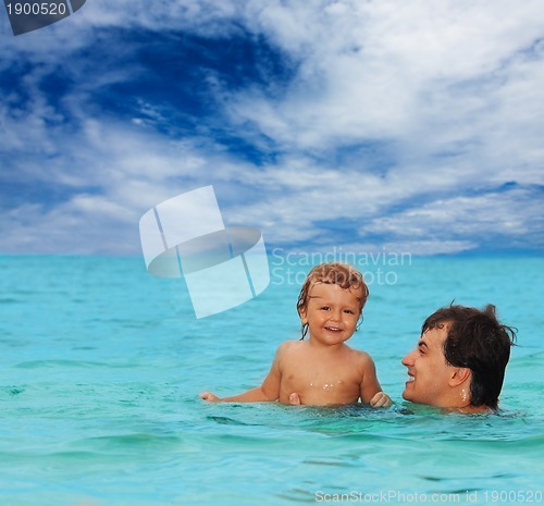 Image of dad and son swimming together
