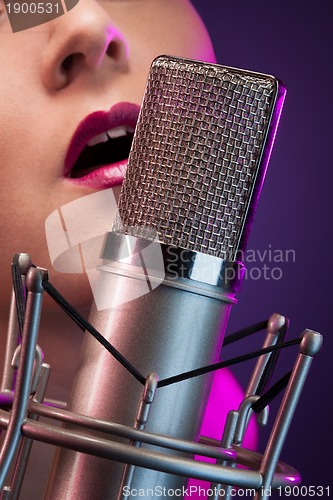 Image of Pretty woman singing on stage