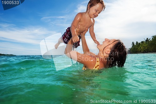 Image of Mother play with her son in the sea