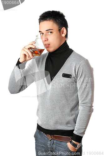 Image of Young man drinking whiskey from a glass. Isolated
