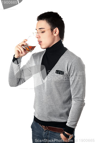 Image of Young man drinking whiskey from a glass