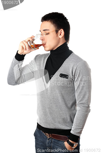 Image of Young man drinking whiskey