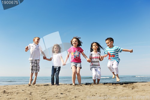 Image of happy child group playing  on beach