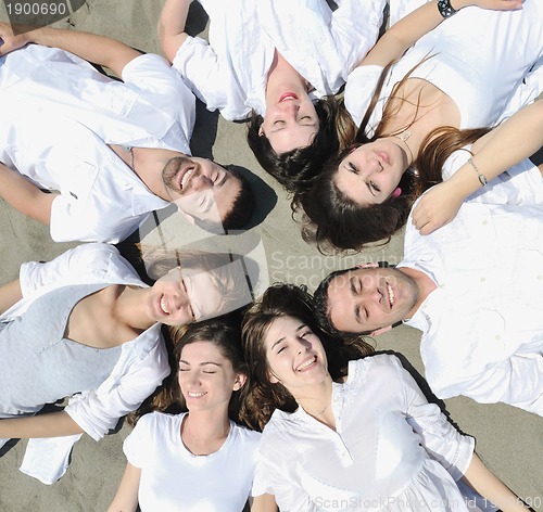 Image of Group of happy young people in have fun at beach