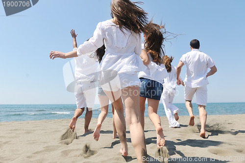 Image of happy people group have fun and running on beach