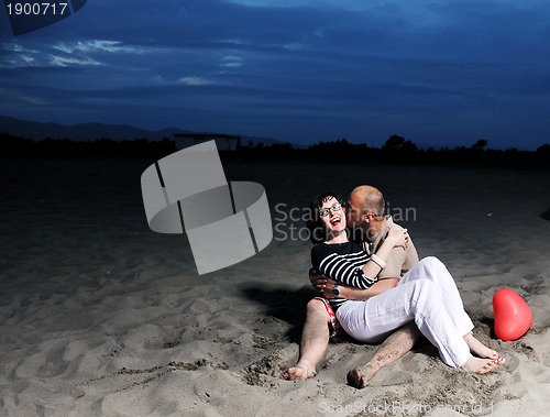 Image of happy young couple have fun on beach