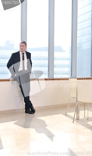 Image of young business man alone in conference room