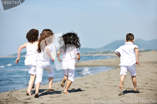 Image of happy child group playing  on beach