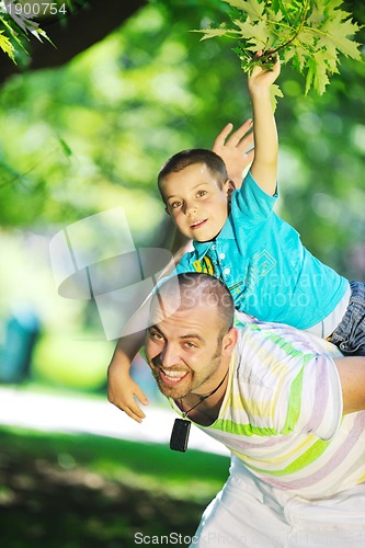 Image of happy father and son have fun at park