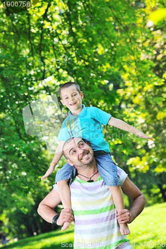 Image of happy father and son have fun at park