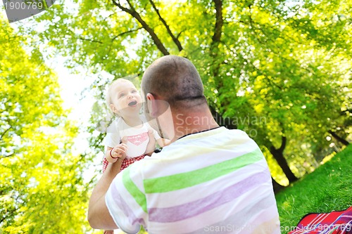 Image of man and baby playing in park
