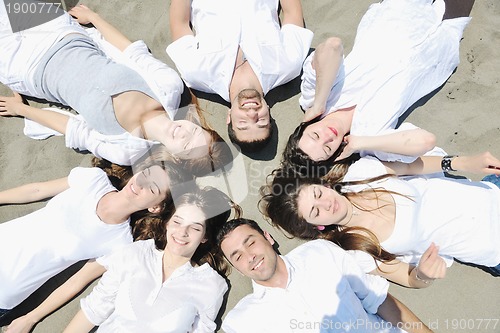 Image of Group of happy young people in have fun at beach
