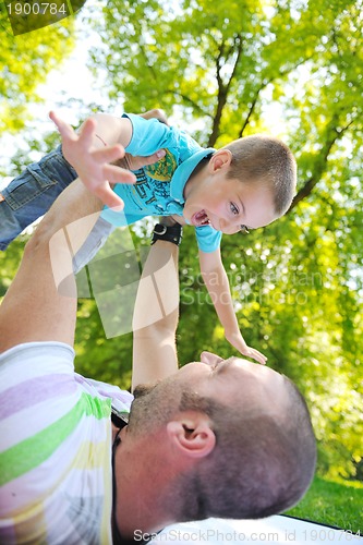 Image of happy father and son have fun at park