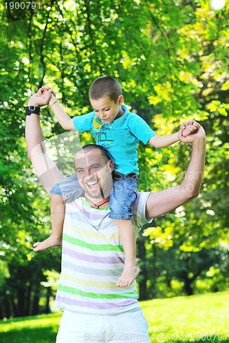 Image of happy father and son have fun at park