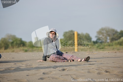 Image of happy young woman on beach