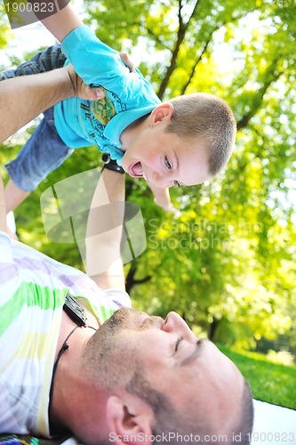 Image of happy father and son have fun at park