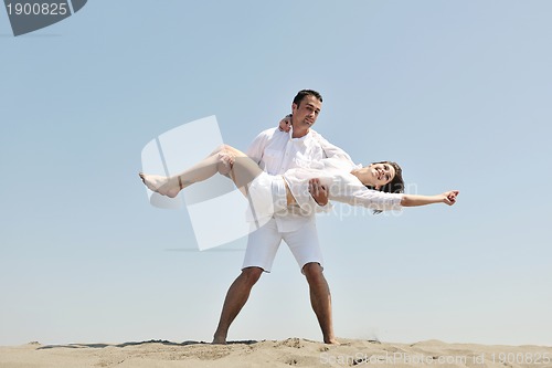 Image of happy young couple have fun on beach